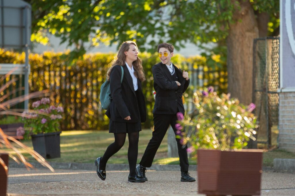 Two children walking through the school grounds