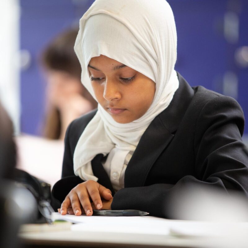 A girl reading in class